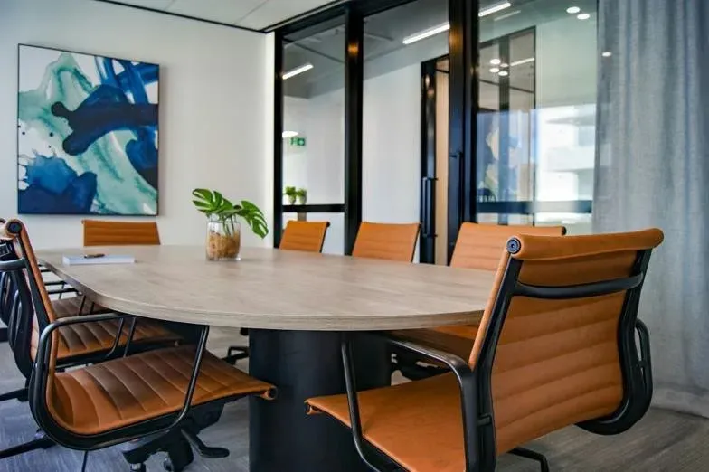 Clean modern boardroom with a meeting table and chairs